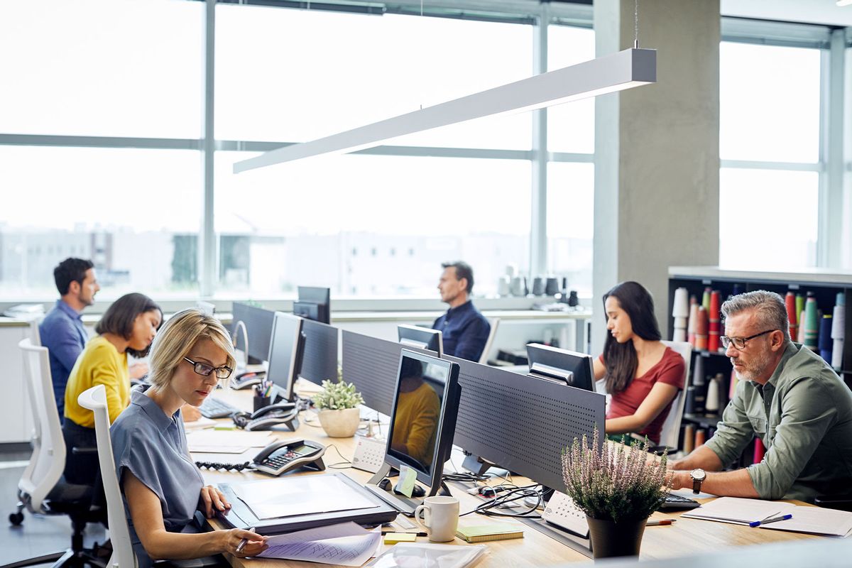 Business people working at desks (Getty Images/Morsa Images)