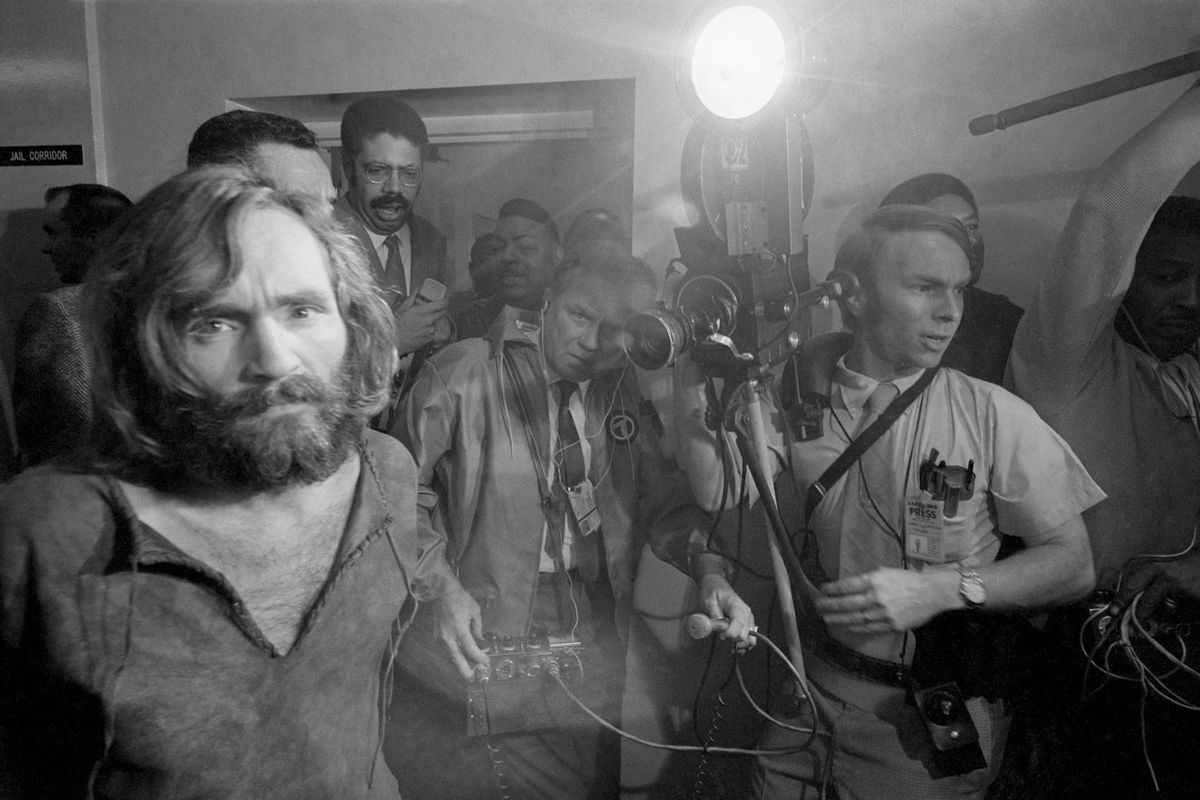 Cameramen film the scene as Charles Manson is brought into the Los Angeles city jail under suspicion of having masterminded the Tate-LaBianca murders of August 1969. (Getty Images)