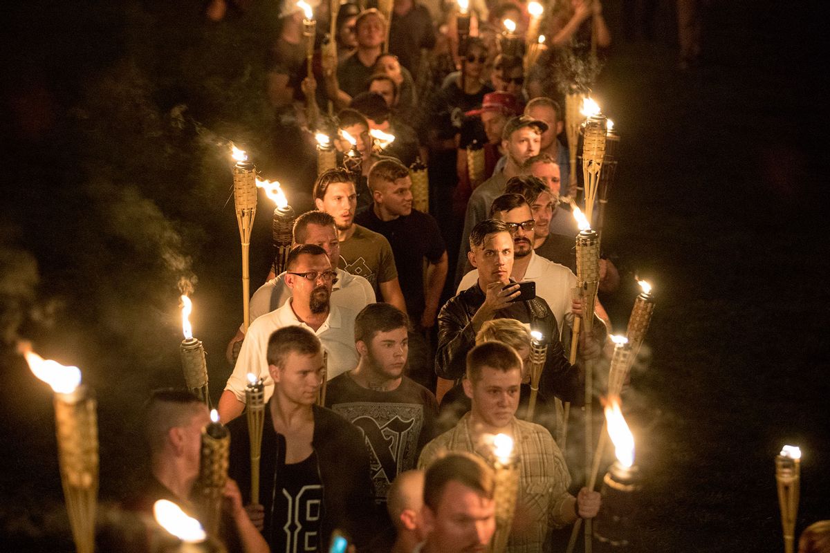 Chanting "White lives matter! You will not replace us! and Jews will not replace us!" several hundred white nationalists and white supremacists carrying torches marched in a parade through the University of Virginia campus on the night of August 11, 2017. (Evelyn Hockstein/For The Washington Post via Getty Images)
