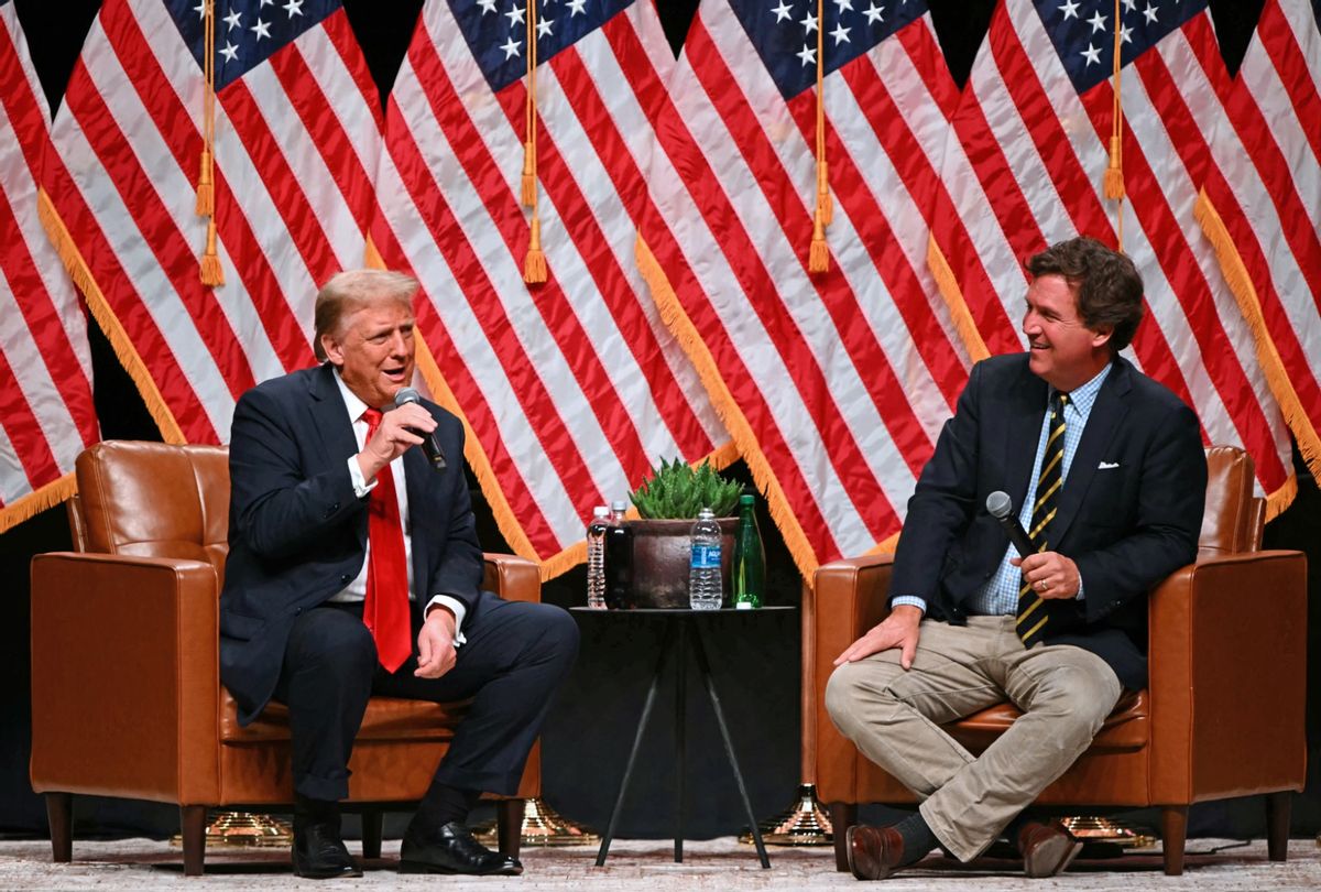 Former President and Republican presidential candidate Donald Trump (L) speaks with Tucker Carlson at Desert Diamond Arena in Glendale, Arizona, on October 31, 2024. (PATRICK T. FALLON/AFP via Getty Images)