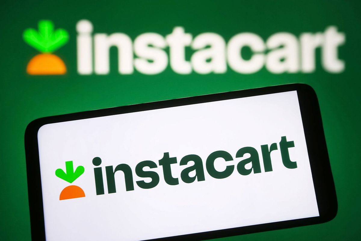 Instacart logo is seen on a smartphone and on a pc screen. (Photo Illustration by Pavlo Gonchar/SOPA Images/LightRocket via Getty Images)