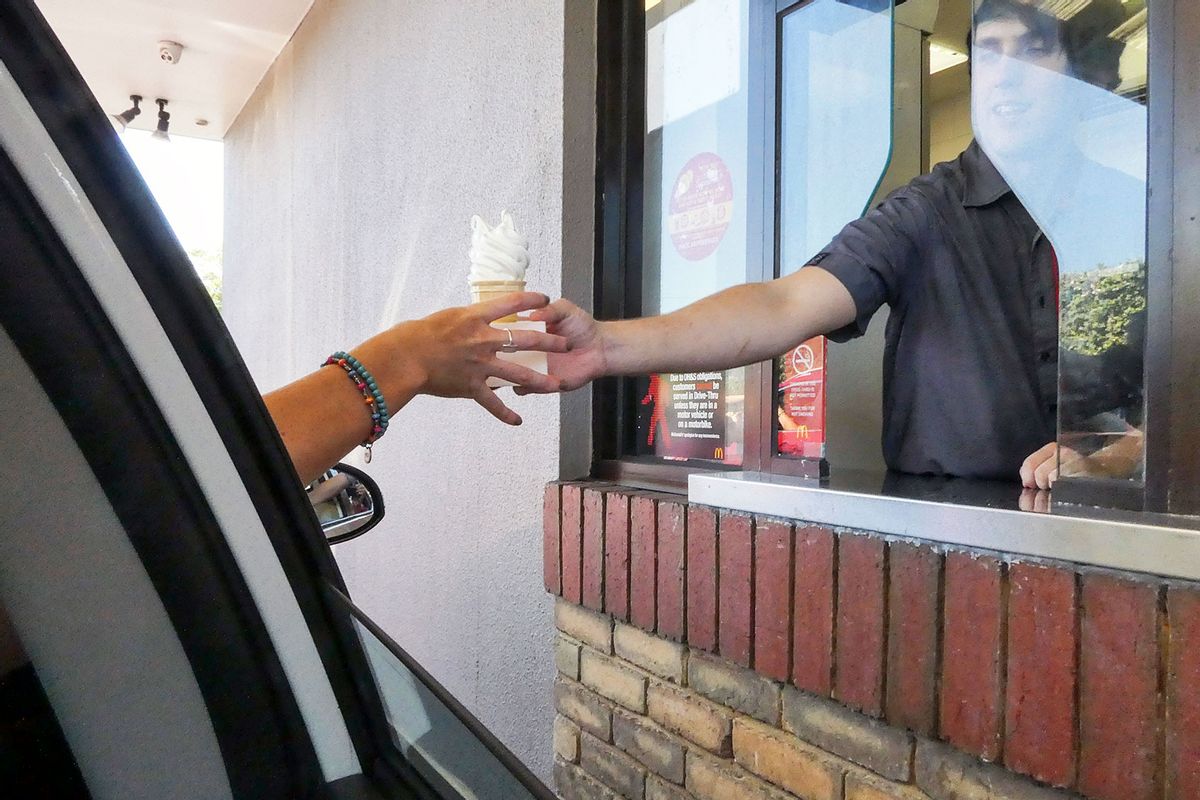 Customer receiving an ice cream at the McDonald's drive through window. (Getty Images/jax10289)