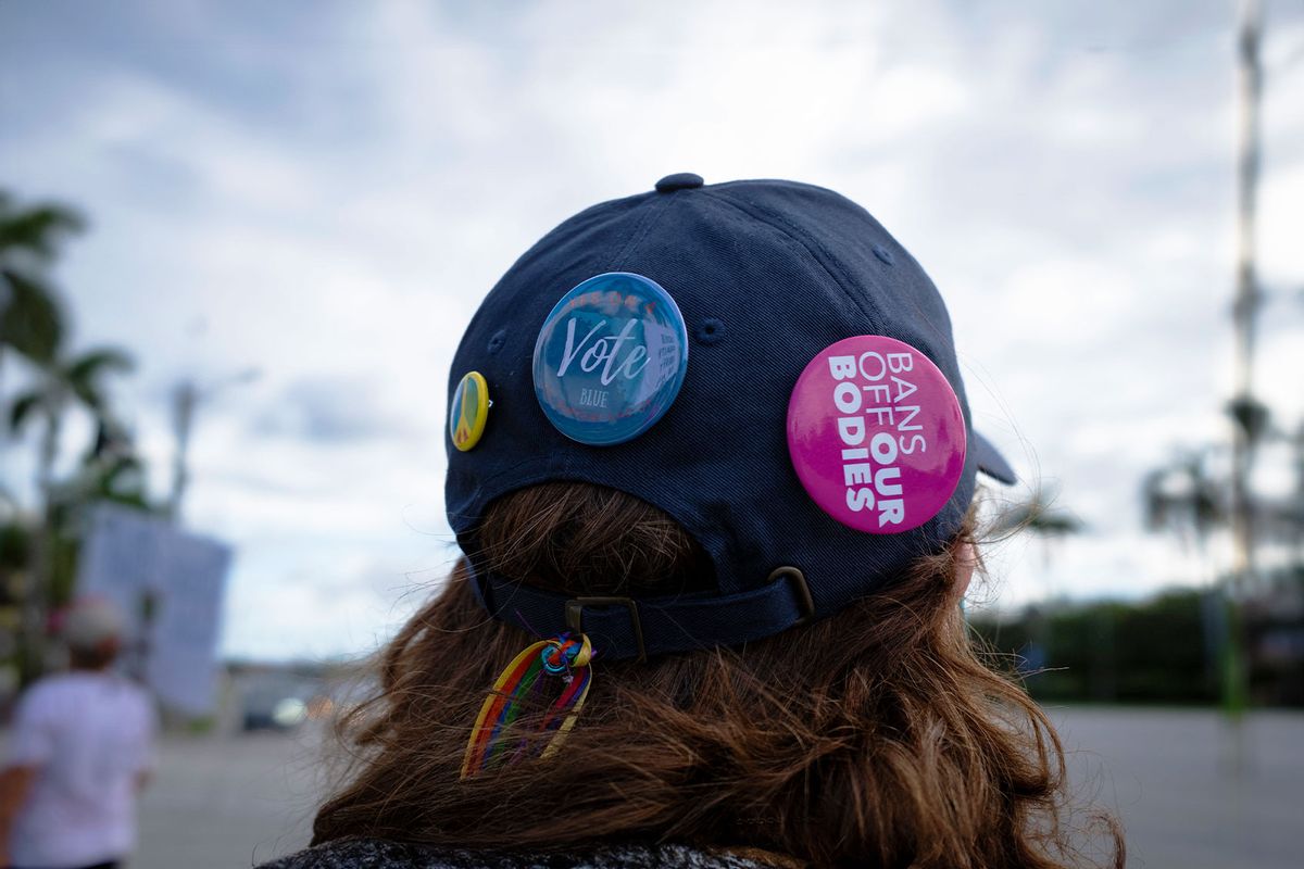 A person wears a hat with pins during a pro-abortion rights rally on the second anniversary of the Supreme Court ruling to overturn Roe v. Wade, in West Palm Beach, Florida, on June 24, 2024. (MARCO BELLO/AFP via Getty Images)