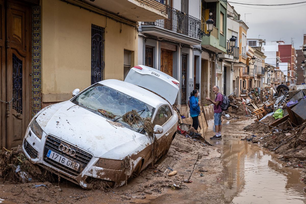 People speak in the street after heavy rain and flooding hit large parts of the country on November 04, 2024 in Paiporta, Spain. (Aldara Zarraoa/Getty Images)