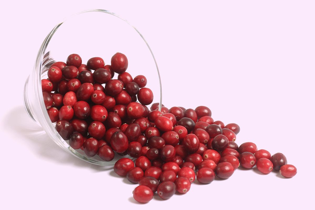 Cranberries spilling out of glass dish (Getty Images/Rosemary Calvert)