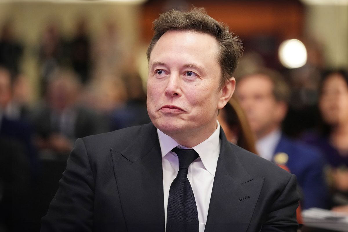 Elon Musk listens as U.S. President-elect Donald Trump addresses a House Republicans Conference meeting at the Hyatt Regency on Capitol Hill on November 13, 2024 in Washington, DC. (Andrew Harnik/Getty Images)