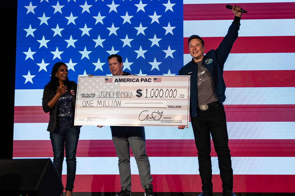 SpaceX and Tesla founder Elon Musk awards Judey Kamora with $1,000,000 during an America PAC town hall on October 26, 2024 in Lancaster, Pennsylvania. (Samuel Corum/Getty Images)