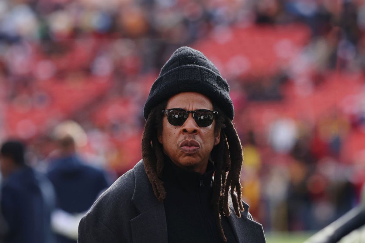 Rapper Jay-Z (C) looks on before a game between the Washington Commanders and the Dallas Cowboys at Northwest Stadium on November 24, 2024 in Landover, Maryland. (Timothy Nwachukwu/Getty Images)