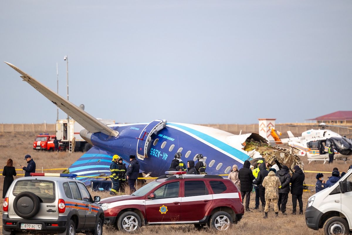 Emergency specialists work at the crash site of an Azerbaijan Airlines passenger jet near the western Kazakh city of Aktau on December 25, 2024.  (Photo by ISSA TAZHENBAYEV/AFP via Getty Images)