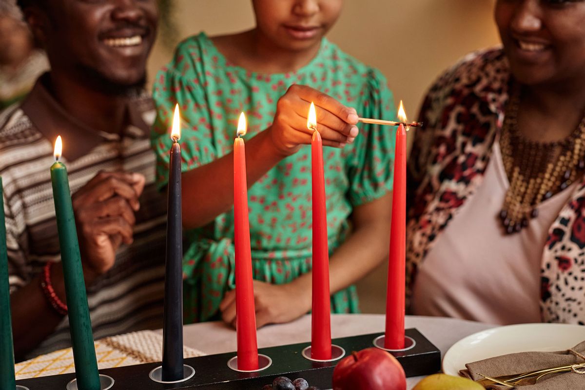 Family lightning colorful Kwanza candles on the dinner table (Getty Images/SeventyFour)