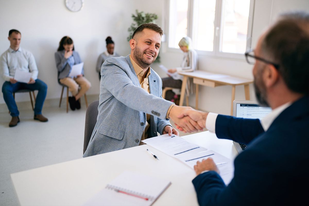 A candidate shaking hands with an interviewer after a job interview (Getty Images/SrdjanPav)