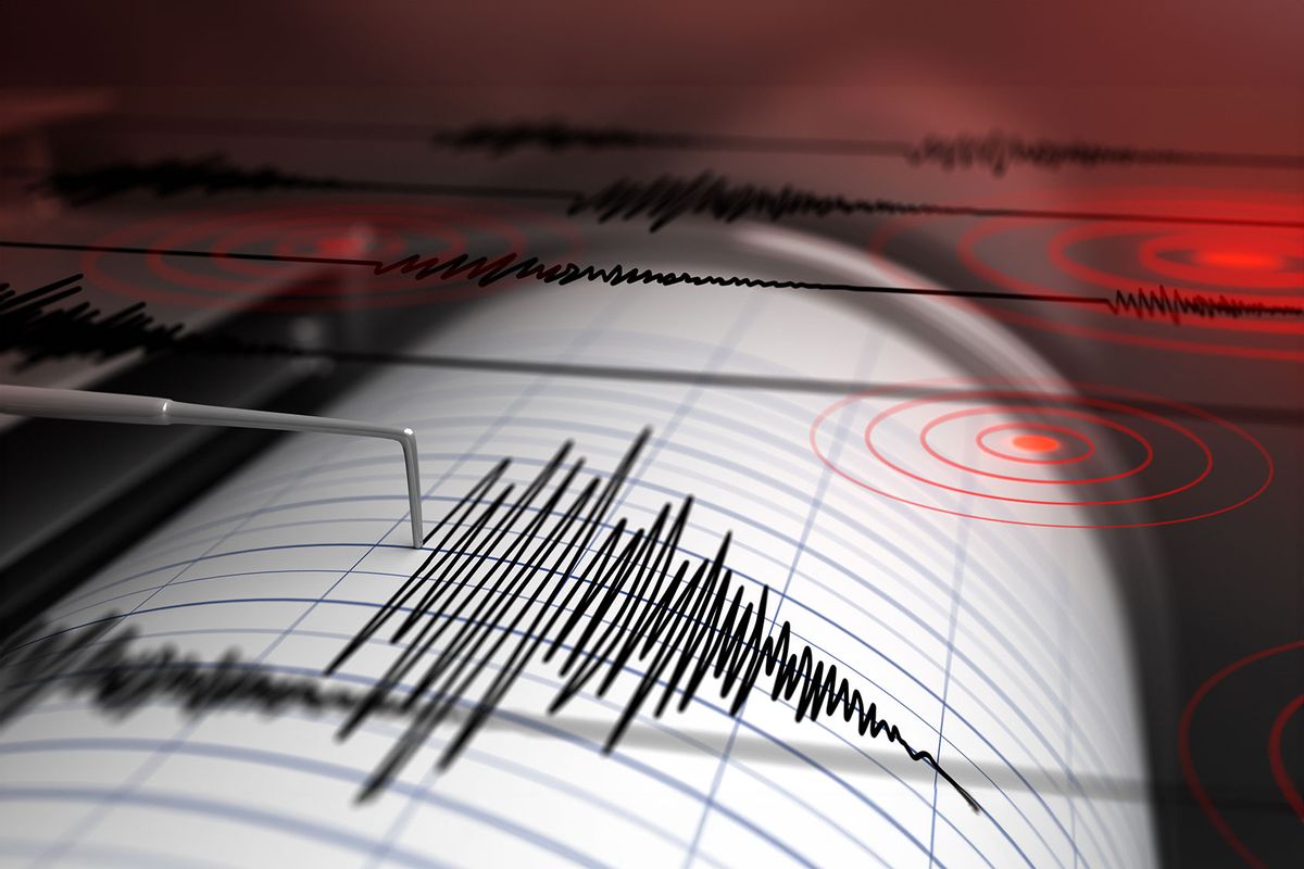 Seismograph with paper in action and earthquake (Getty Images/Petrovich9)