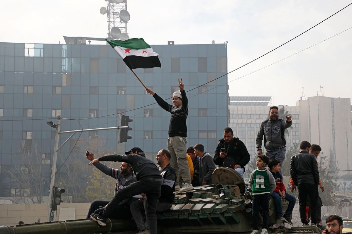 People react to the fall of Syrian regime in Umayyad Square on December 8, 2024 in Damascus, Syria. (Ali Haj Suleiman/Getty Images)