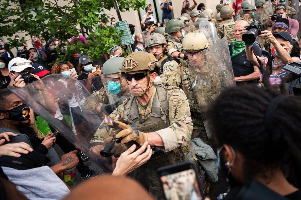 Protesters scuffle with members of the US Army as they demonstrate the death of George Floyd near the White House on June 3, 2020, in Washington, DC. (JIM WATSON/AFP via Getty Images)