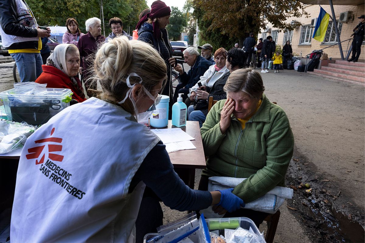 At a mobile clinic set up for Ukrainian refugees fleeing the front lines in 2022, a woman receives medical attention from a Doctors Without Borders physician. (Paula Bronstein/Getty Images)