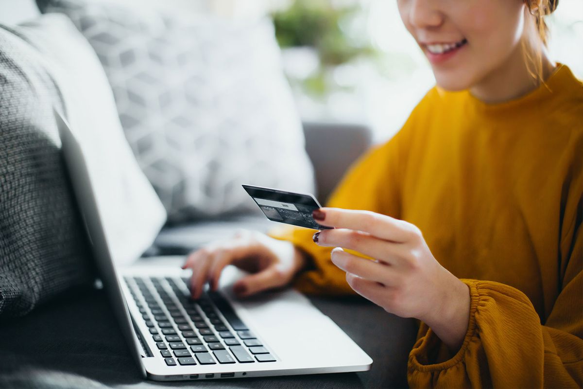 Close up of a woman at her laptop, using her credit card. (Getty Images/d3sign)