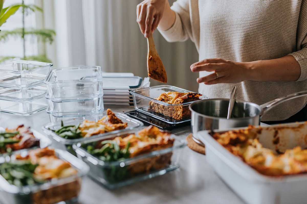 Woman weighing lunch boxes as part of healthy meal prep (Getty Images/Johner Images)