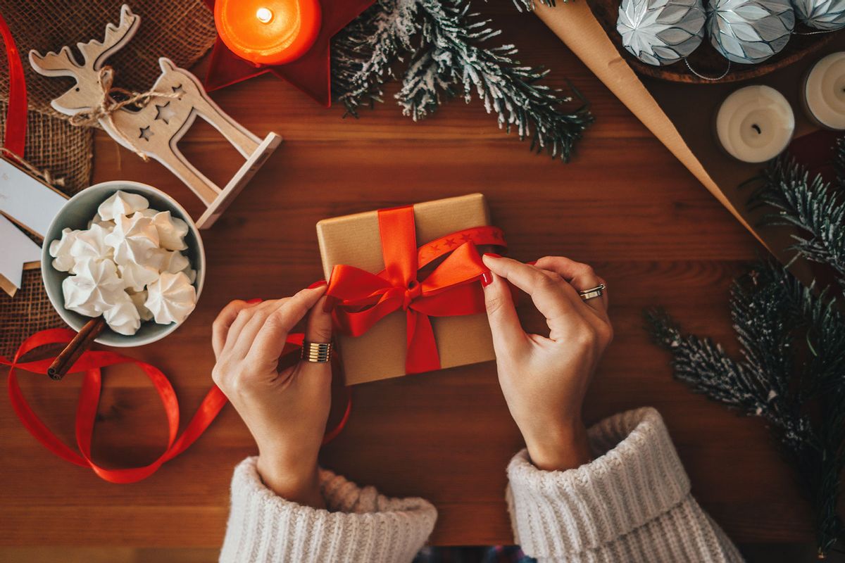 Woman wrapping gifts (Getty Images/Xsandra)