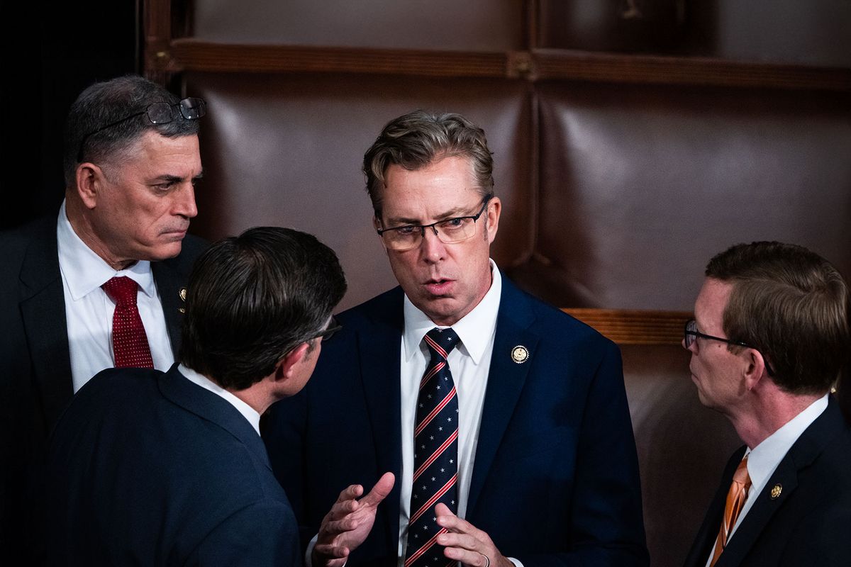 Rep. Andy Ogles (R-Tenn.) speaking to  Rep. Andrew Clyde (R-Ga.), Speaker of the House Mike Johnson (R-La.), and Rep. Dusty Johnson (R-S.D.) in the House chamber of the U.S. Capitol before Johnson won the speakership for the 119th Congress on Friday, January 3, 2025. (Tom Williams/CQ-Roll Call, Inc via Getty Images)