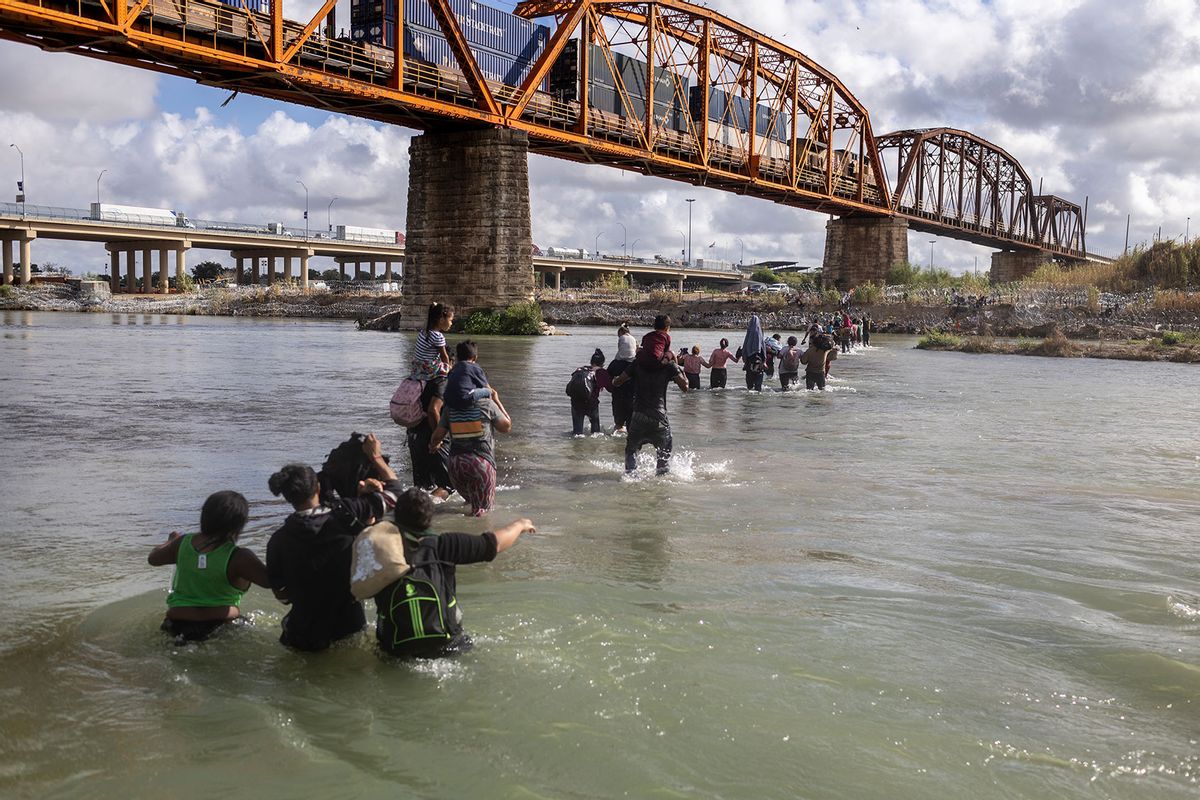 Asylum seekers cross the Rio Grande from Mexico into the United States on September 30, 2023 in Eagle Pass, Texas. (John Moore/Getty Images)