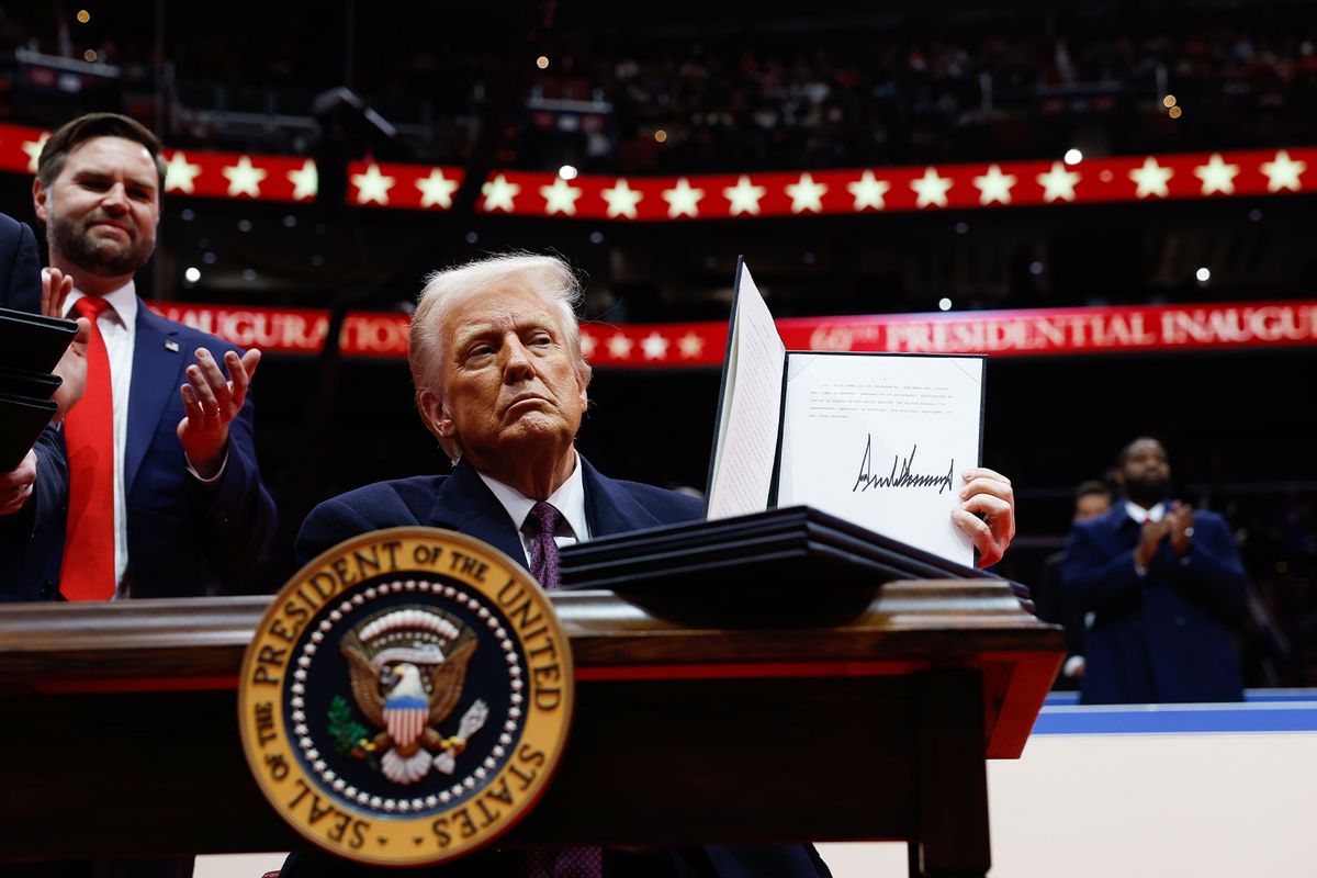 U.S. President Donald Trump holds up an executive orders after signing it during an indoor inauguration parade at Capital One Arena on January 20, 2025 in Washington, DC. (Anna Moneymaker/Getty Images)