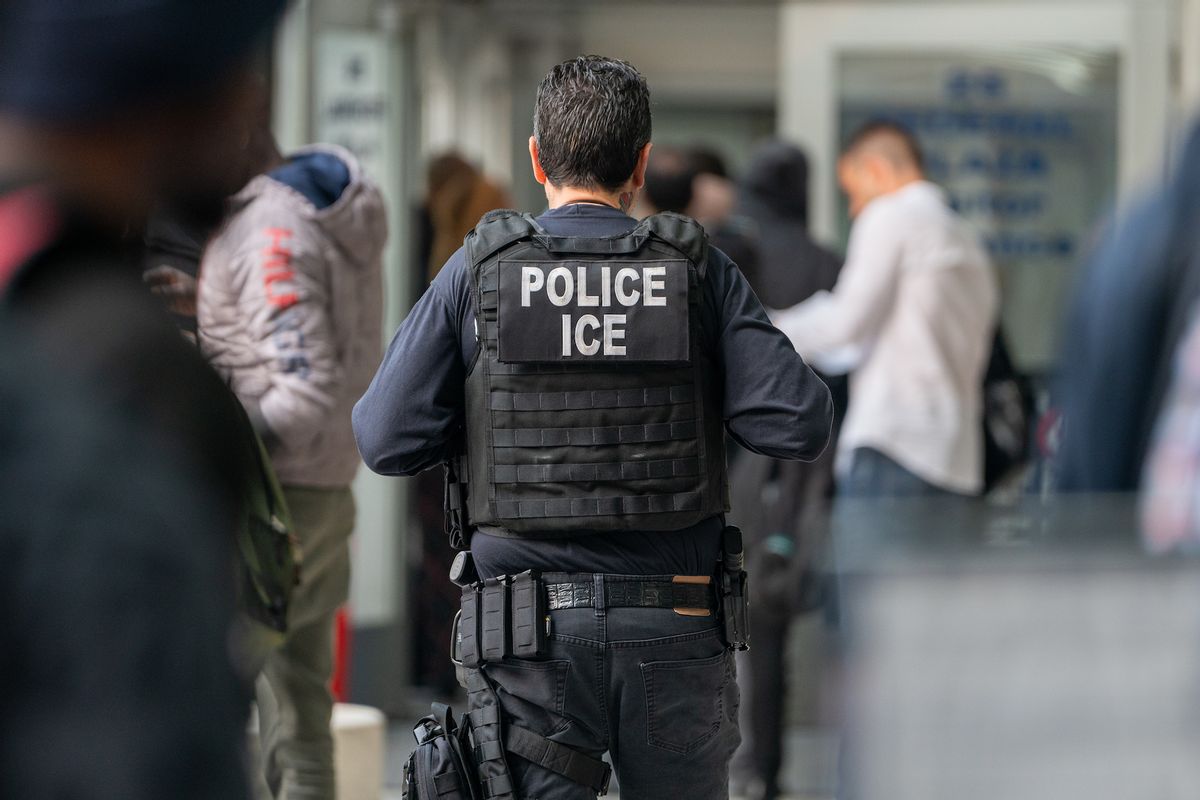 An ICE agent monitors hundreds of asylum seekers being processed upon entering the Jacob K. Javits Federal Building on June 6, 2023 in New York City. (Photo by David Dee Delgado/Getty Images)