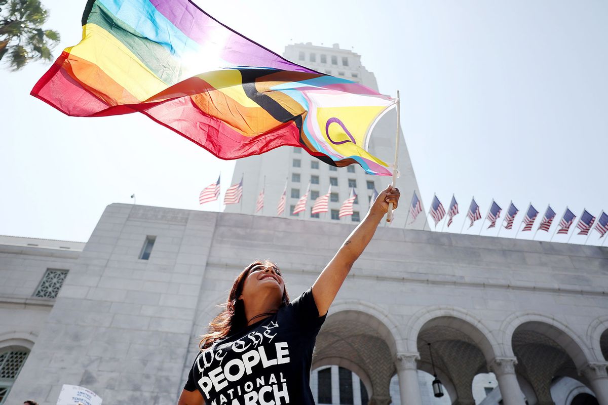 A demonstrator waves the intersex-inclusive Pride flag outside City Hall during the We The People March in protest of the hundreds of bills being introduced which are directed towards LGTBQ+ people, people of color and women on July 2, 2023 in Los Angeles, California. (Mario Tama/Getty Images)