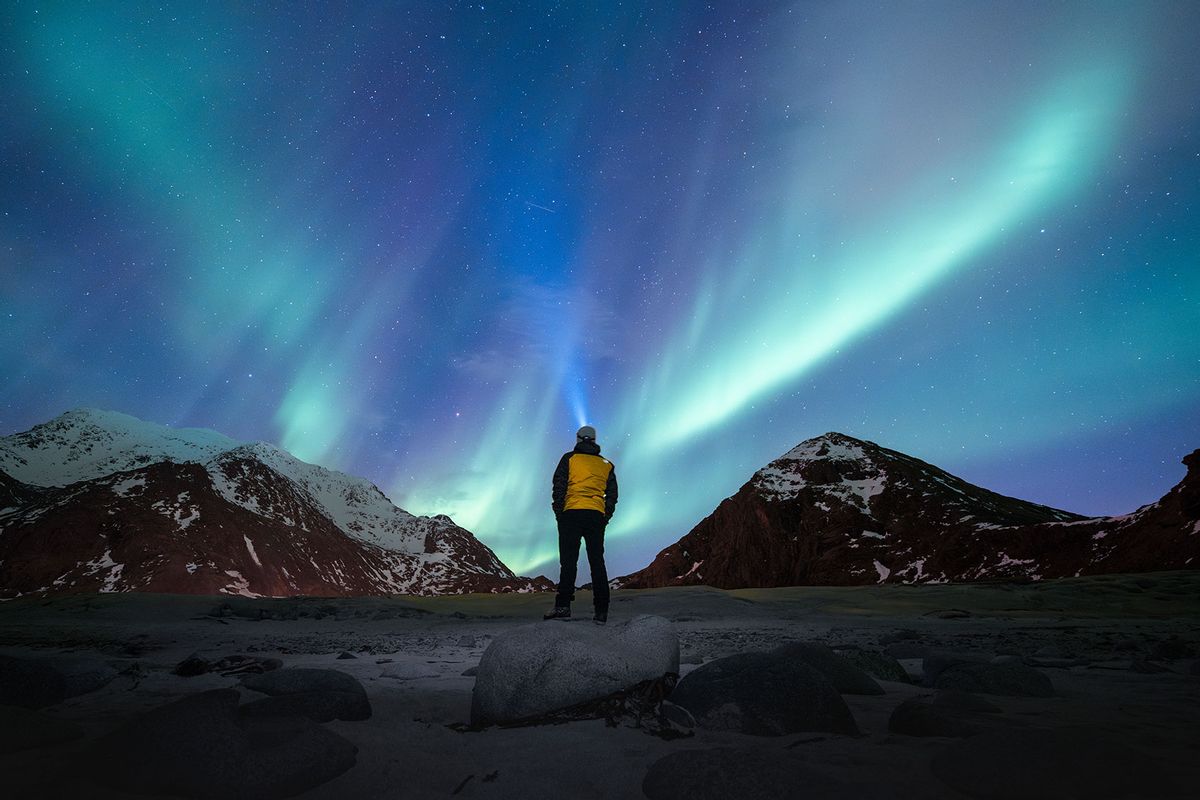 Person admiring the Northern Lights (aurora borealis) (Getty Images/Marco Bottigelli)