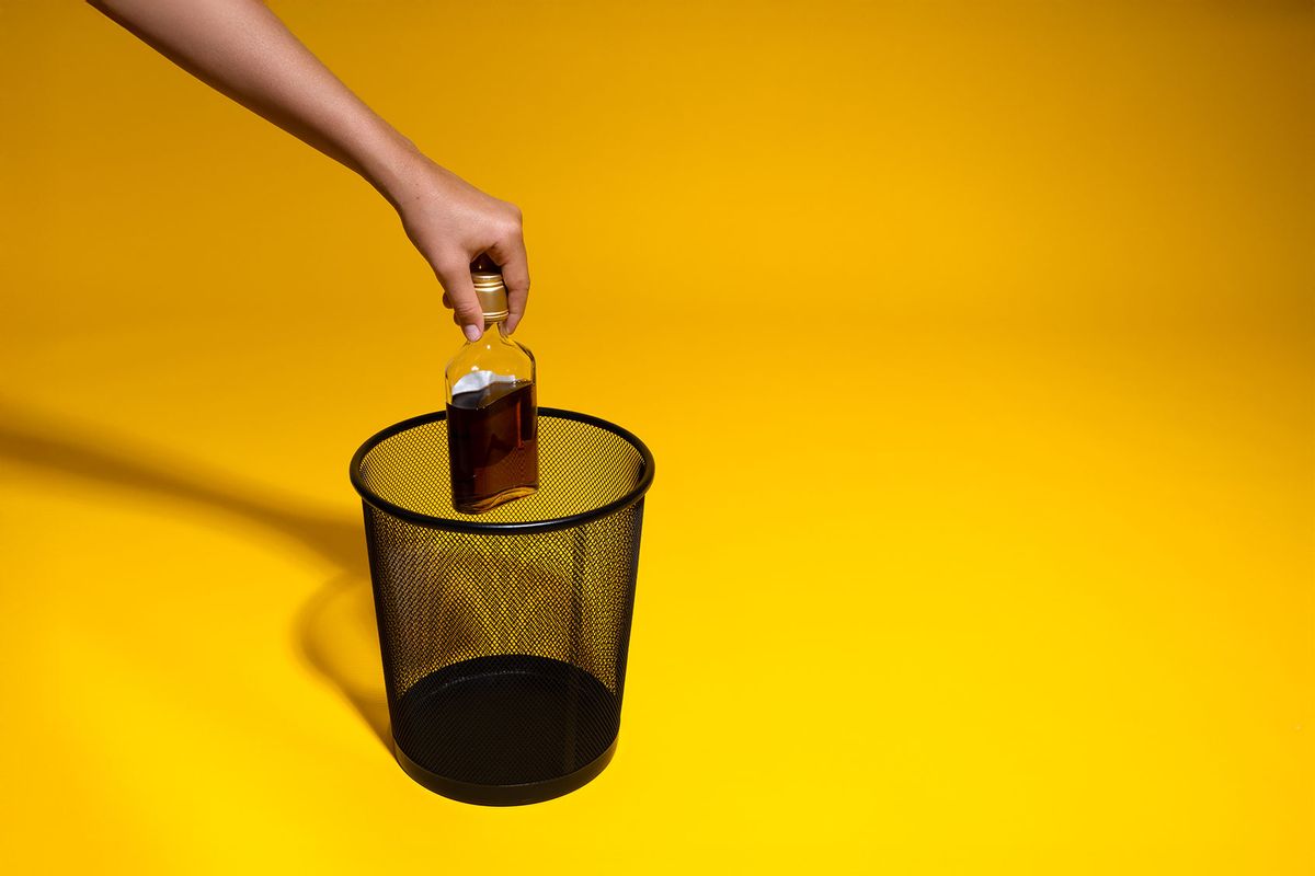 Throwing out a liquor bottle (Getty Images/Stanislav Sorokin)