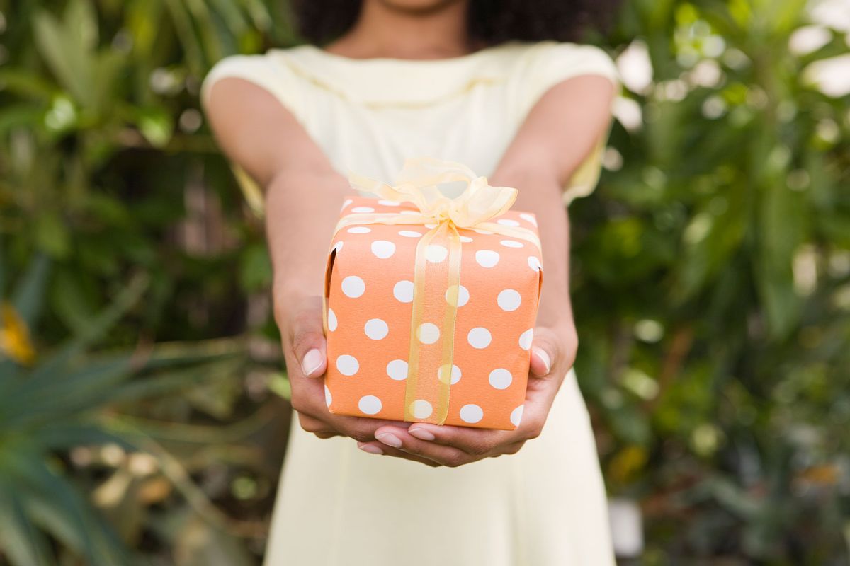 Woman Holding Present (Getty Images/Jupiterimages)