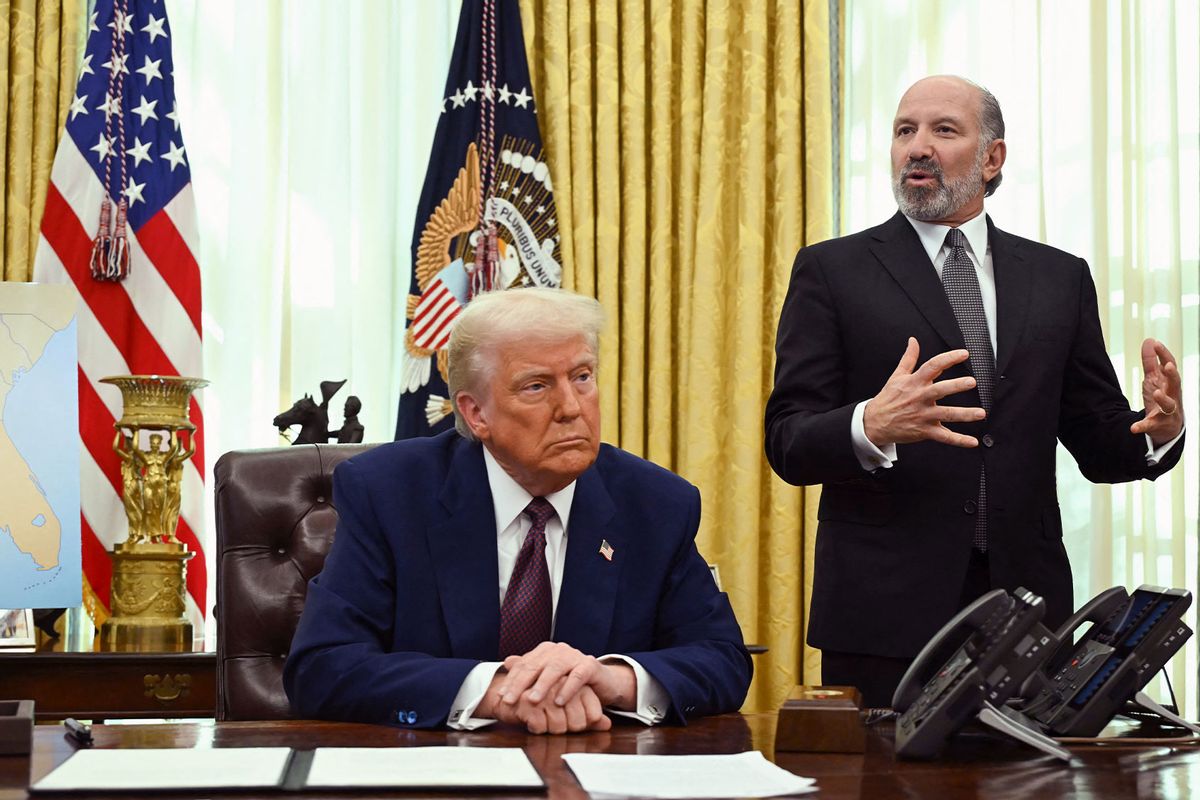 US President Donald Trump listens as Commerce Secretary Howard Lutnick (R) speaks in the Oval Office of the White House as he announces reciprocal tariffs, in Washington, DC, on February 13, 2025. (ANDREW CABALLERO-REYNOLDS/AFP via Getty Images)