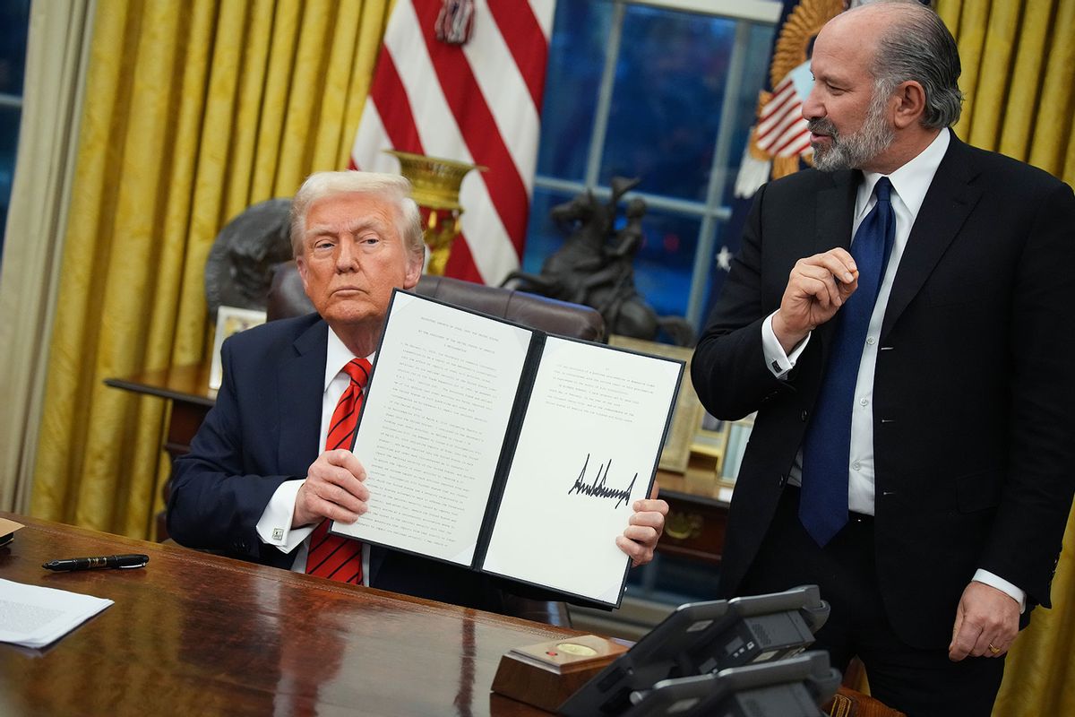 U.S. President Donald Trump, joined by Commerce Secretary nominee Howard Lutnick, holds up an executive order imposing tariffs on steel imports after signing the order in the Oval Office at the White House on February 10, 2025 in Washington, DC. (Andrew Harnik/Getty Images)