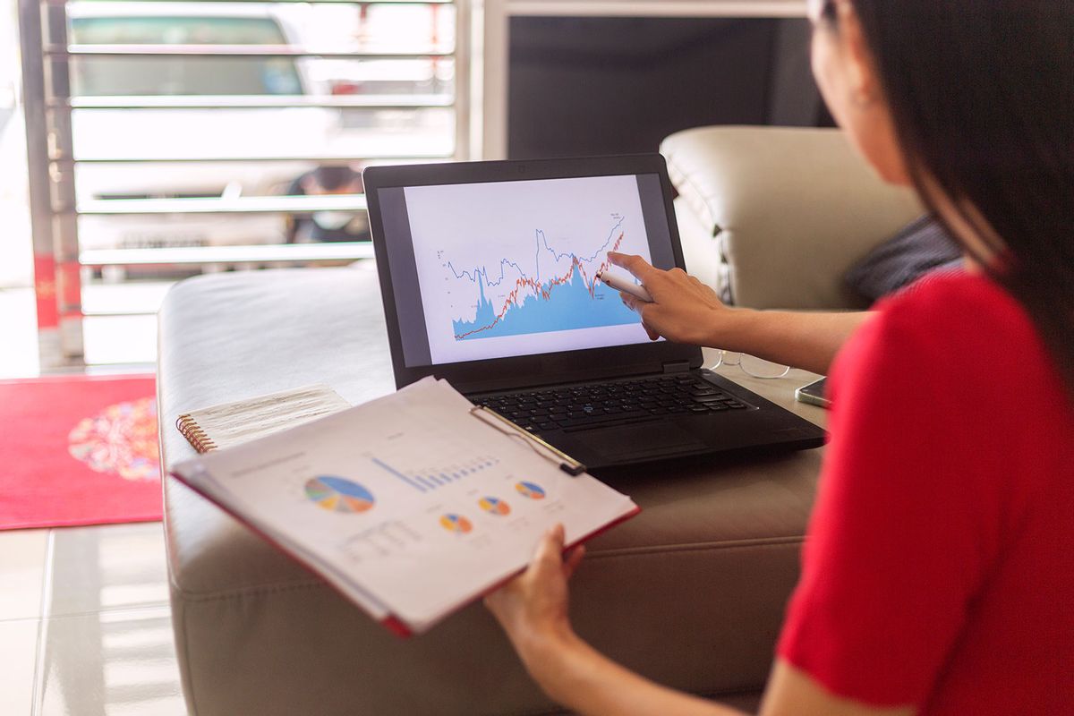 Female entrepreneur analyzing graph on laptop (Getty Images/gahsoon)