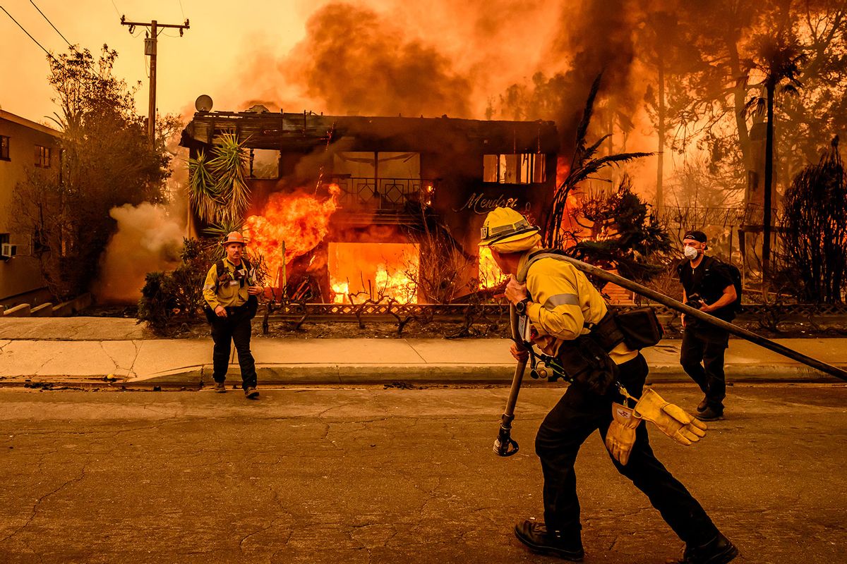 Firefighters work the scene as an apartment building burns during the Eaton fire in the Altadena area of Los Angeles county, California on January 8, 2025. (JOSH EDELSON/AFP via Getty Images)