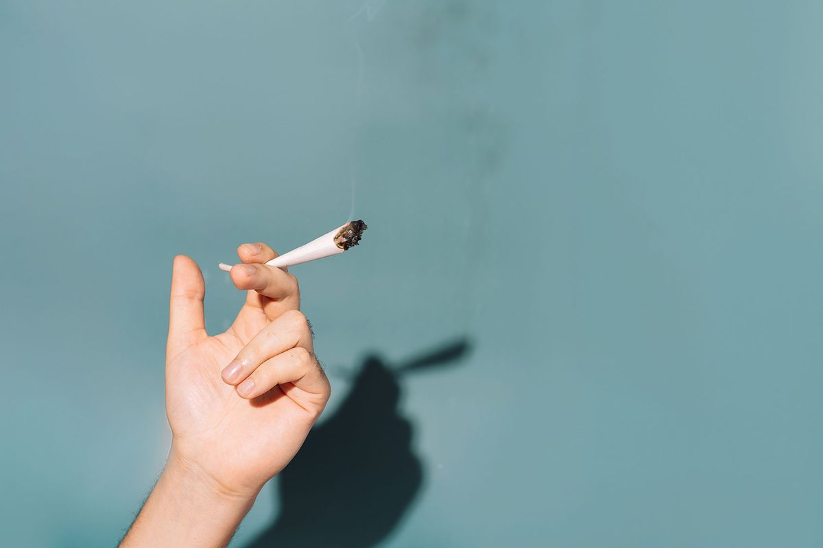 In hand cigarette filled with cannabis (Getty Images/Anastassiya Bezhekeneva)