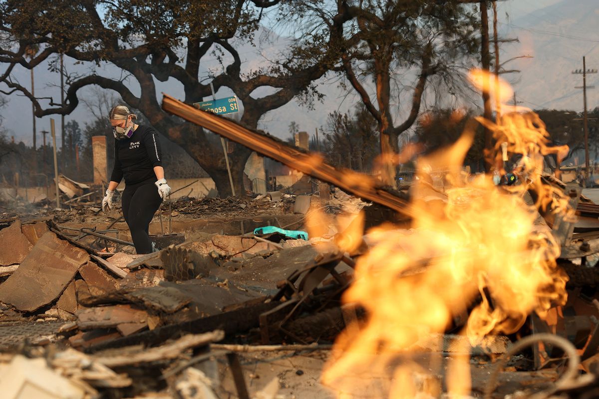 A resident inspects the remains of her home that was destroyed by the Eaton Fire on January 09, 2025 in Altadena, California. (Justin Sullivan/Getty Images)