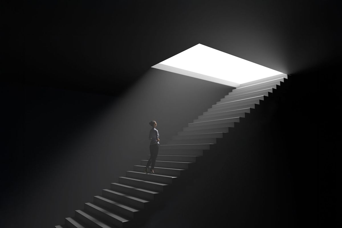 Woman climbs the stairs from darkness to light (Getty Images/Photobank Kiev)