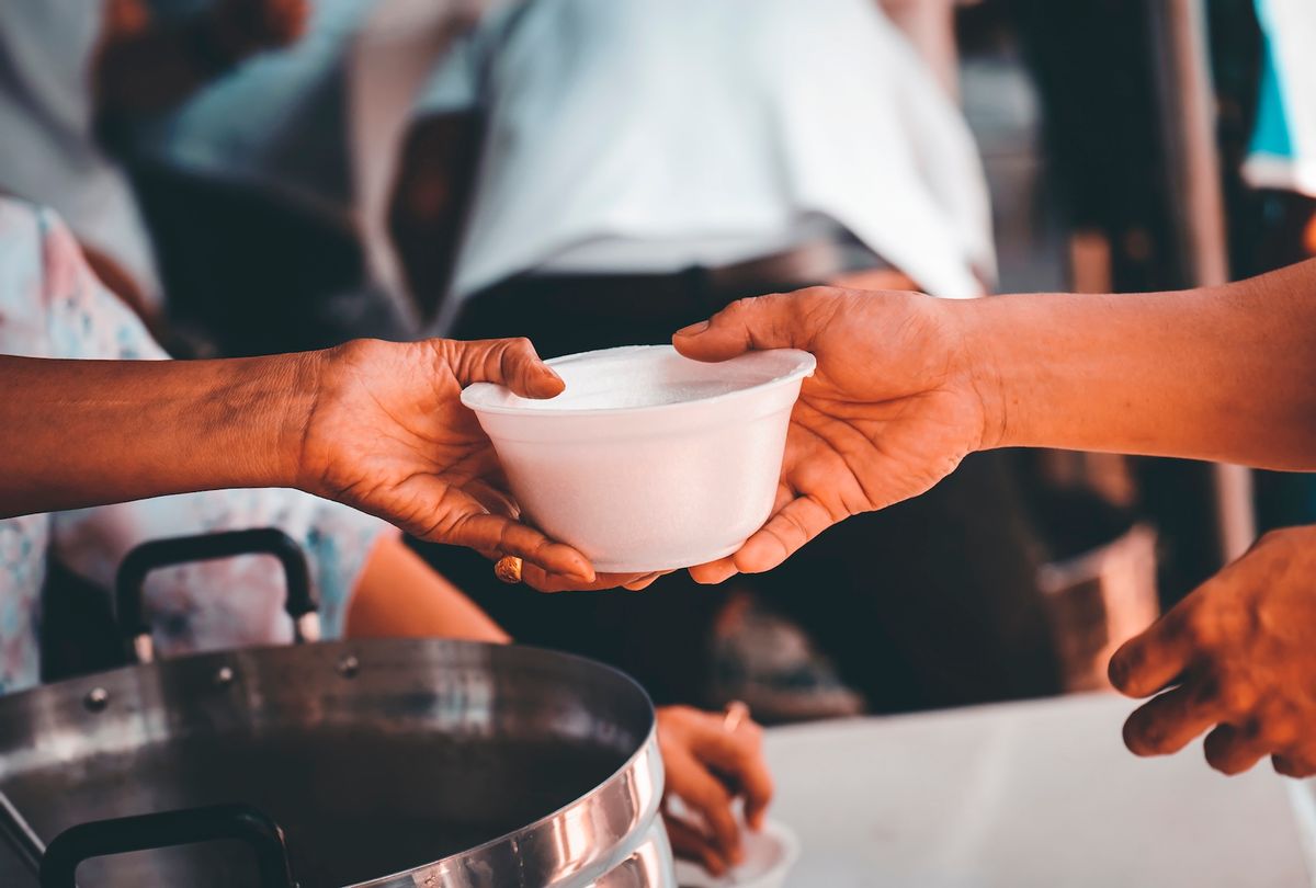 Volunteers offering food to help the homeless. (kuarmungadd / Getty Images)