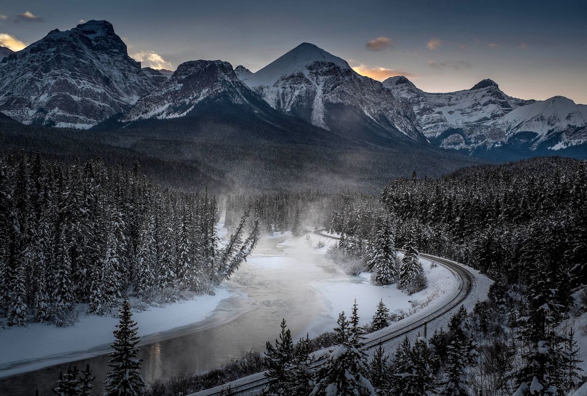 A view of the famous 'Morant's Curve' offering a beautiful view of the frozen Bow River and the Canadian Pacific Railway at Banff National park near Lake Louise, Canada, late on December 06, 2013.  (Photo by JOE KLAMAR/AFP via Getty Images)