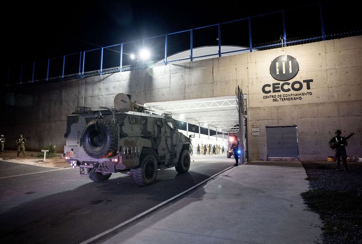 In this handout photo provided by the Salvadoran government, members of the Salvadoran army stand guard at the gates of the Terrorism Confinement Center (CECOT) at CECOT on March 16, 2025 in Tecoluca, El Salvador. (Salvadoran Government via Getty Images)