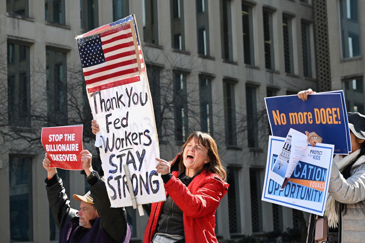 Protesters hold signs in solidarity with the American Federation of Government Employees of District 14 at a rally in support of federal workers at the Office of Personnel Management in Washington, DC, March 4, 2025. (ALEX WROBLEWSKI/AFP via Getty Images)