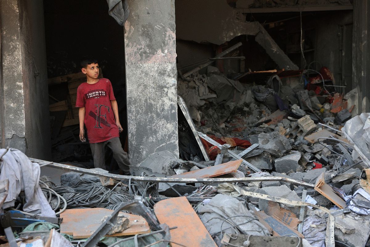 A Palestinian youth inspects the rubble from the destroyed house of the Qrayqea family in the Shujaiya district in eastern Gaza City on March 18, 2025 following Israeli strikes at dawn. (OMAR AL-QATTAA/AFP via Getty Images)