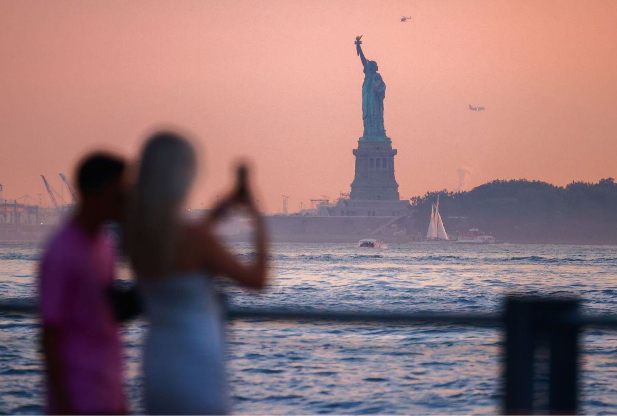 Sunset over the East River and a view on the Statue of Liberty in New York City, United States of America on July 7, 2024. (Beata Zawrzel/NurPhoto via Getty Images)