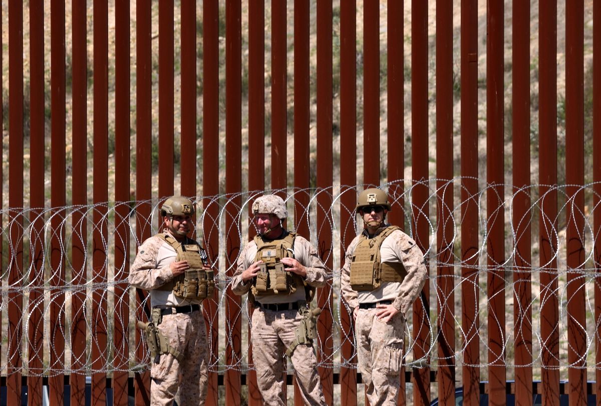 SAN YSIDRO, CA - MARCH 21, 2025 - - Members of the U.S. military stand in front of the border wall along the U.S. and Mexico border near San Ysidro on March 21, 2025. The U.S. Border Patrol and members of the U.S. military held a press conference to address the strengthening of the U.S./Mexico border with new barriers and concertina wire to stop the flow of migrants from entering the U.S. (Photo by Genaro Molina/Los Angeles Times via Getty Images)