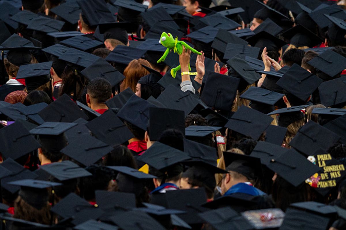A graduate holds a Kermit the Frog doll as he addressed the graduates at University of Maryland on May 22, 2025. (The Washington Post / Contributor / Getty Images)