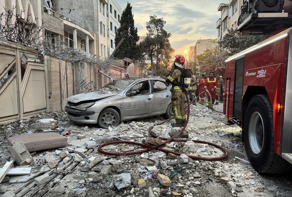 First-responders gather outside a building that was hit by an Israeli strike in Tehran on June 13, 2025. (MEGHDAD MADADI/TASNIM NEWS/AFP via Getty Images)