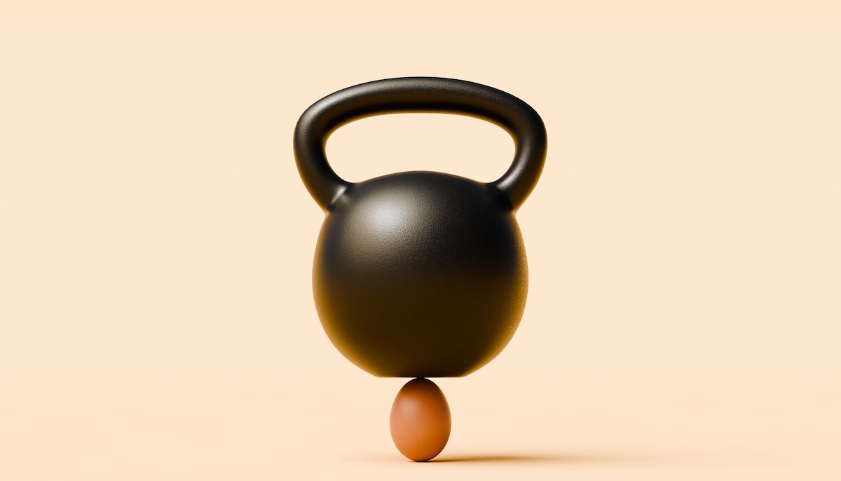 A kettlebell balances on an egg  (J Studios / Getty Images)