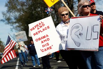 Tea Party activists demonstrate during a tax day rally outside the Korean War Memorial in Hauppauge