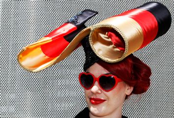 A racegoers poses in her hat on the first day of racing at Royal Ascot in southern England