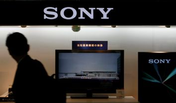 A man walks past a display of Sony's products near its headquarters in Tokyo